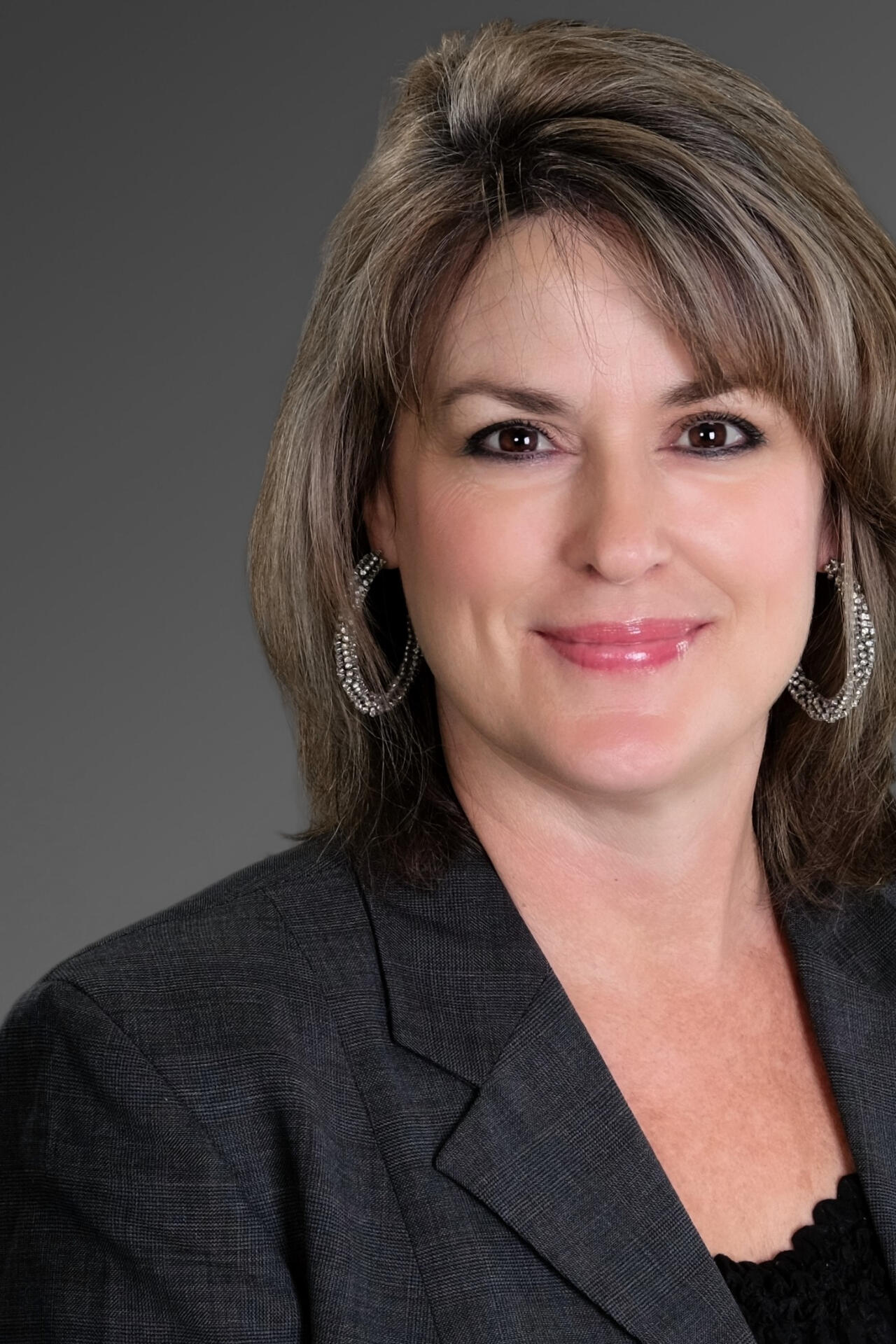 Woman working on her laptop overlooking the ocean.